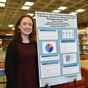 Student posing with research project.