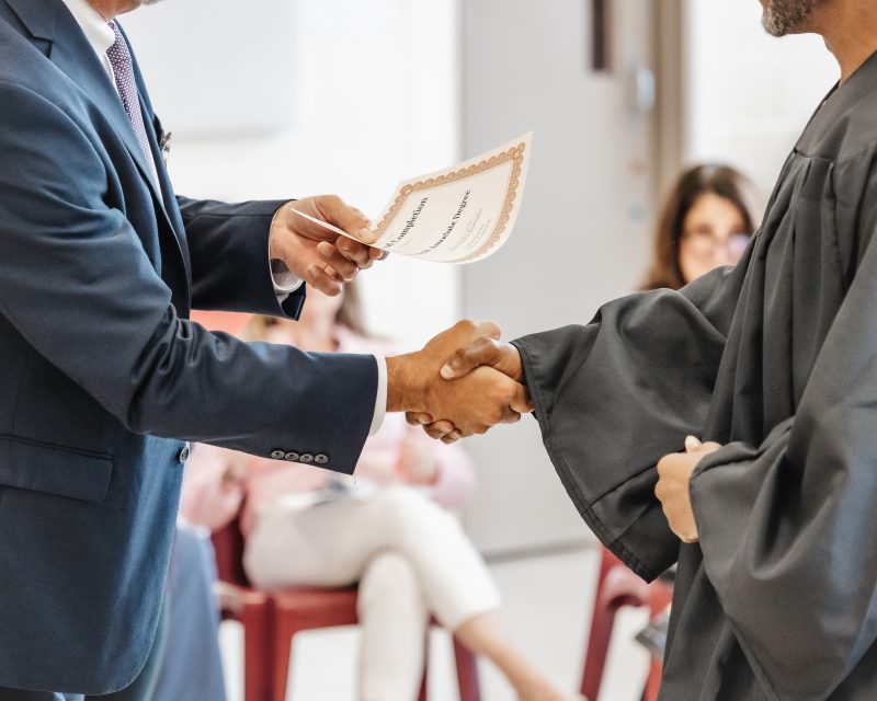 Graduate shaking a president's hand.