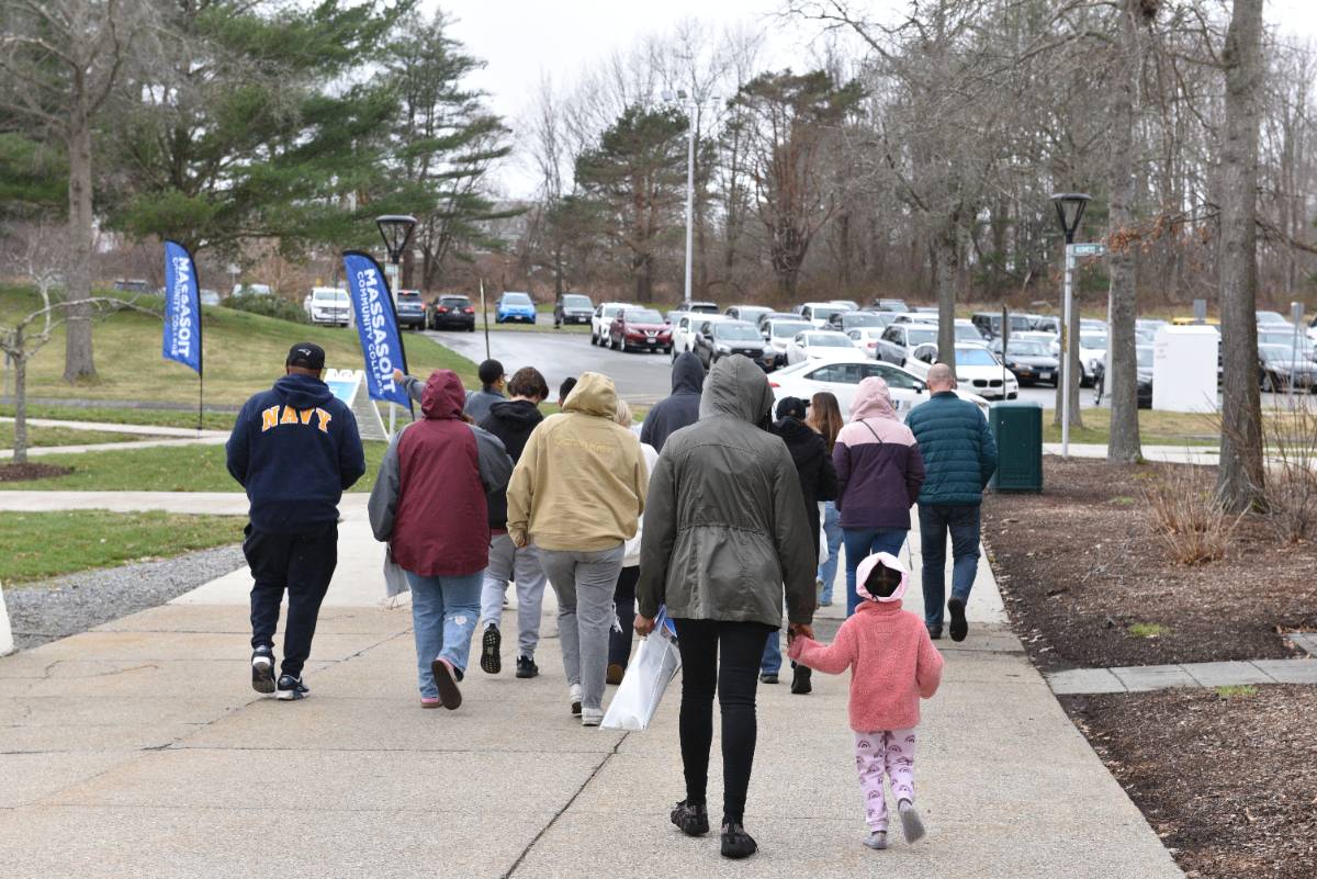 Group of people being led on a tour of a college campus.