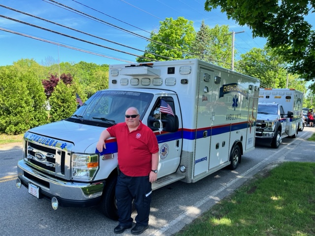 Paramedic Program Director Scott Meagher standing in front of a Rehoboth ambulance.
