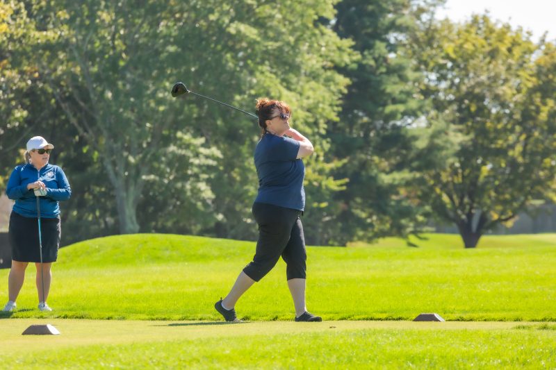 Woman playing golf at a golf course.