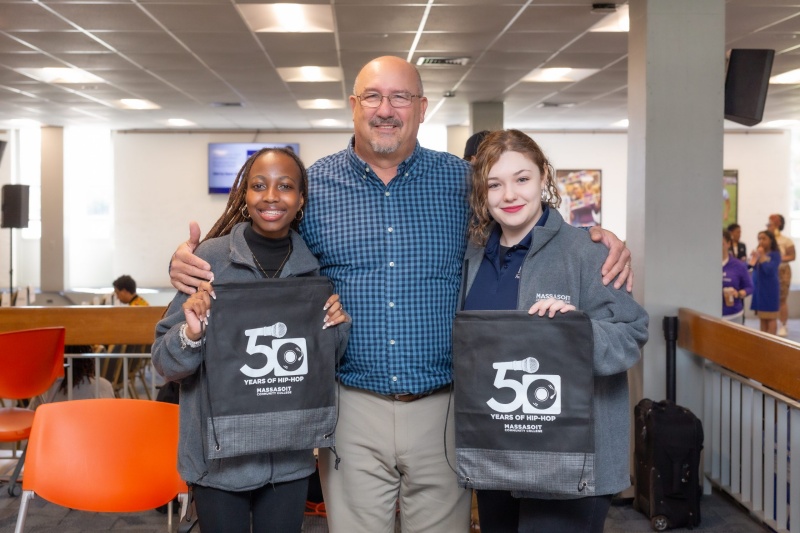 President Mitchell posing with two students at the 50th Anniversary of Hip-Hop Symposium held on April 27, 2024.