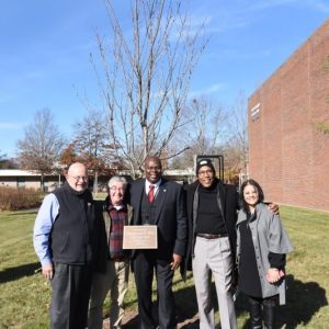 Ifill stands with with current and former members of the Board of Trustees,