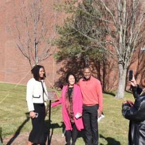 Ifill's family posing with the tree planted in his honor at Massasoit.