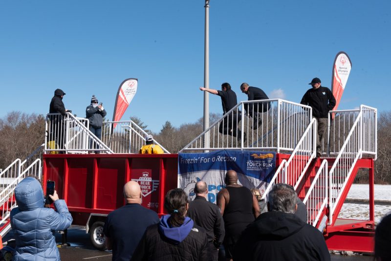 Participants jumping into mobile polar plunge tank.