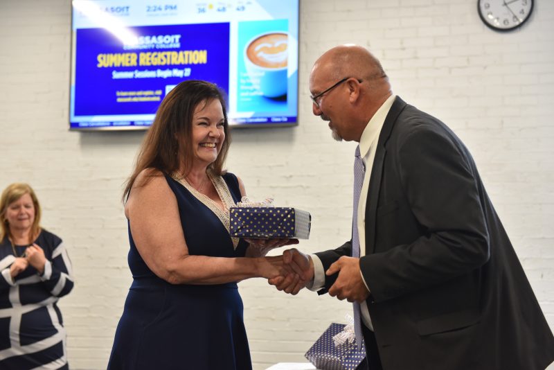 Retiree Nancy Clancy shakes President Mitchell's hand.