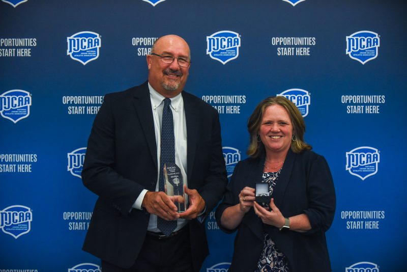Two people accepting an award.