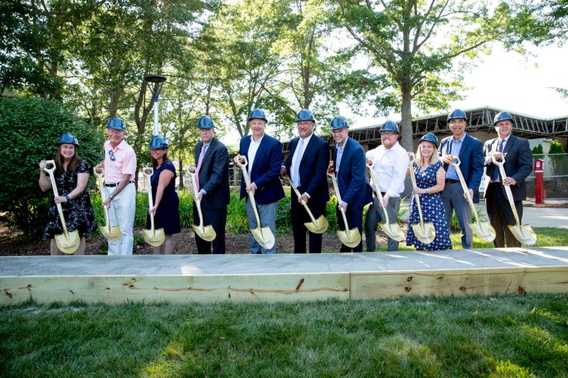 People holding shovels and breaking ground.
