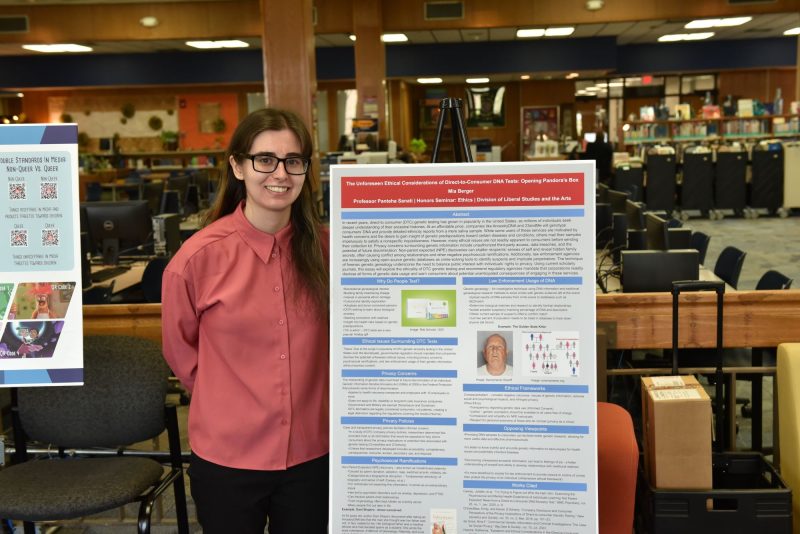 Student presenting project in the library.